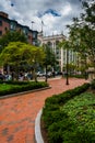 Gardens along a brick path in Boston, Massachusetts.