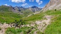 Gardetta - Mountain bike on scenic trail with view of Rocca La Meja in Maira valley in the Cottian Alps, Piedmont Royalty Free Stock Photo