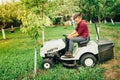 Gardner using lawn mower for cleaning and landscaping works