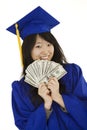 Asian teenage in blue graduation gown holding US money