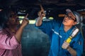 Gargae customer and car mechanic together investigate maintenance and repair programe at garage and car maintenance station Royalty Free Stock Photo