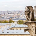 Gargoyle of the Notre Dame in Paris, France, with aerial view of the city Royalty Free Stock Photo