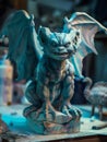 Gargoyle sculpture glowing with bioluminescence, artisan chiseling under moonlight, mystical workshop, soft focus, close-up view,