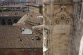 Gargoyle and statue on the roof of Milan Cathedral. Royalty Free Stock Photo