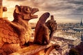 Gargoyles or chimeras on the Notre Dame de Paris overlooking Paris, France Royalty Free Stock Photo