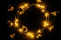 Garland christmas. Xmas party ornament decor with Golden light garland decoration, gold bulb isolated on black Royalty Free Stock Photo