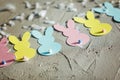 Garland with colorful paper rabbits on concrete background. Concept Easter Bunny Banner. Top view