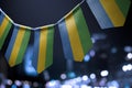 A garland of Gabon national flags on an abstract blurred background