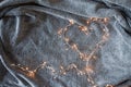 Garland heart with glowing lights in the background of a fluffy grey blanket