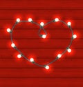 Garland heart shaped on red wooden background for Valentines Day
