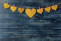 A garland of hearts on clothespins on a blue wooden background. view from above . space for text Royalty Free Stock Photo