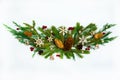 The garland is made of fir and juniper branches, fir and pine cones, red berries, wooden snowflakes, stars and bells on a white ba Royalty Free Stock Photo