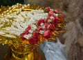 The garland is placed on a golden pedestal on blur background, nature, object, worship, buddha, copy space