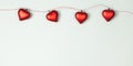 Garland of red glass hearts. Blue banner with copy space for Valentine`s Day