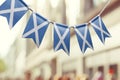 A garland of Scotland national flags on an abstract blurred background Royalty Free Stock Photo