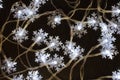 Garland snowflakes on the Christmas tree. Christmas decor. Glowing snowflakes. Preparation for the New year and Christmas. Royalty Free Stock Photo