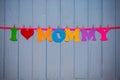 Garland with text `I love mommy` of colorful paper alphabet