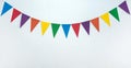A garland of triangular multicolored paper flags on a white background.