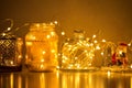 Garlands and decorations, golden lights on a wire, a candlestick, a vase, a snow glass ball and other
