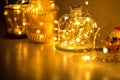 Garlands and decorations to create a cozy home, Golden lights on a wire, a candlestick, a vase, a snow glass ball and other