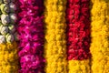 Garlands made of fresh flowers: yellow marigolds, red roses, pink orchids, and lotuses