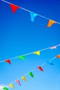 Garlands of multicolored party flags against blue sky Royalty Free Stock Photo