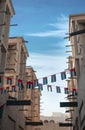 Garlands or small buntings of UAE flags displayed over old buildings in bur Dubai. Royalty Free Stock Photo