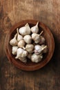 Garlic cloves in wooden plate
