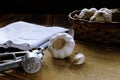 Garlic basket, garlic bulb and garlic press on wooden cutting board, Vintage effect photo treatment