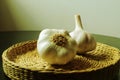 Garlic basket. Wicker basket with garlic bulbs with green filter. Brazilian seasoning