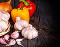 Garlic and bell pepper on a wooden table