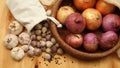 Garlic, black pepper and onions in a basket on a wood floor