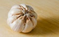 Garlic bulb on a wooden cutting board