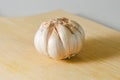 Garlic bulb on a wooden cutting board