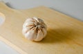 Garlic bulb on a wooden cutting board