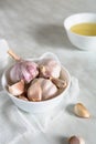 Garlic bulbs and cloves and garlic oil on a light kitchen table Royalty Free Stock Photo