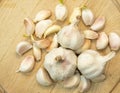 Garlic bulbs and cloves on a wooden cutting board Royalty Free Stock Photo