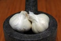 Garlic bulbs and mortar and pestle Royalty Free Stock Photo