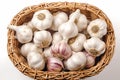 Garlic bulbs neatly arranged in wicker basket on white background Royalty Free Stock Photo