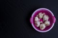 Garlic bulbs in pink bowl