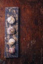 Garlic bulbs on wooden boards background. Natural antioxidant, anticoagulant, spicy vegetable, flavouring. Copy space, vertical