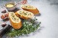 Garlic butter on Toasted Baguette bread with Salt, Pepper, Thyme and Olive. White background. Top view. Copy space Royalty Free Stock Photo