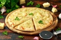 Garlic cheese pizza on wooden board with herbs. Royalty Free Stock Photo