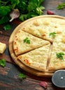 Garlic cheese pizza on wooden board with herbs. Royalty Free Stock Photo