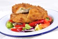 Garlic chicken kiev with mixed leaf salad Royalty Free Stock Photo