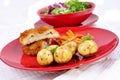 Garlic chicken kiev with young potatoes Royalty Free Stock Photo