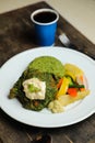 Garlic Chicken With Rice and Veg served in plate with cold drink, spoon and fork isolated on wooden board side view of thai food