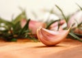 Garlic clove with fresh rosemary in background