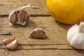 Garlic clove and lemon on a wooden background. The concept of the treatment of colds with folk remedies