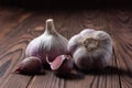 Garlic cloves and bulb on wooden table. Fresh peeled garlics and bulbs Royalty Free Stock Photo
